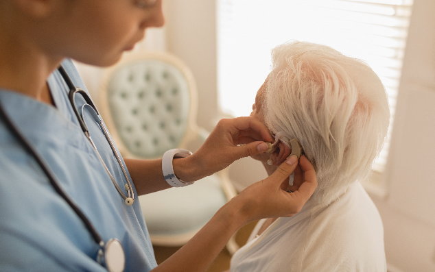 female-physician-inserting-hearing-aid-on-senior-w-h3slz75-resized__634x397.jpg